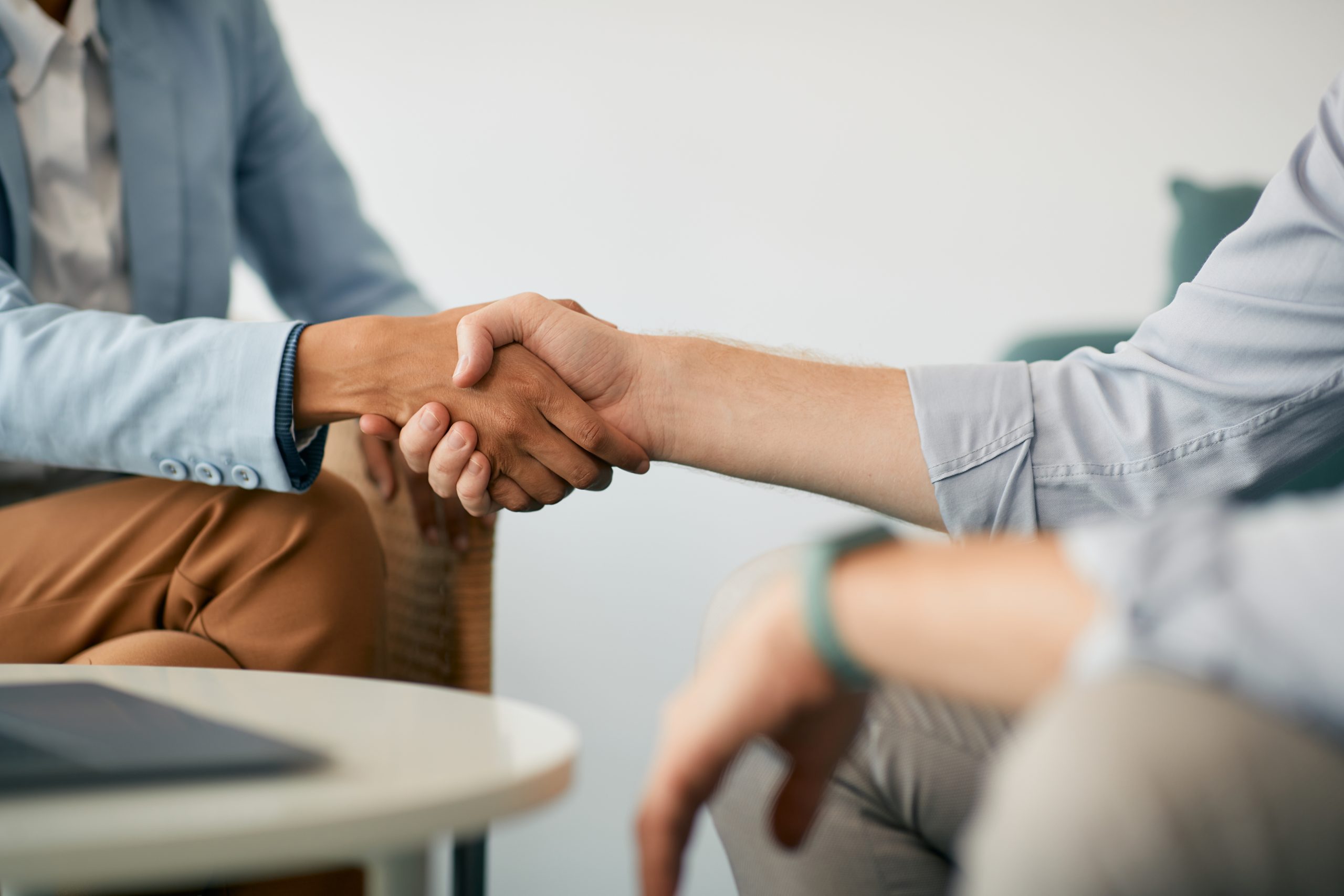 Close-up of business people handshaking on meeting in office.